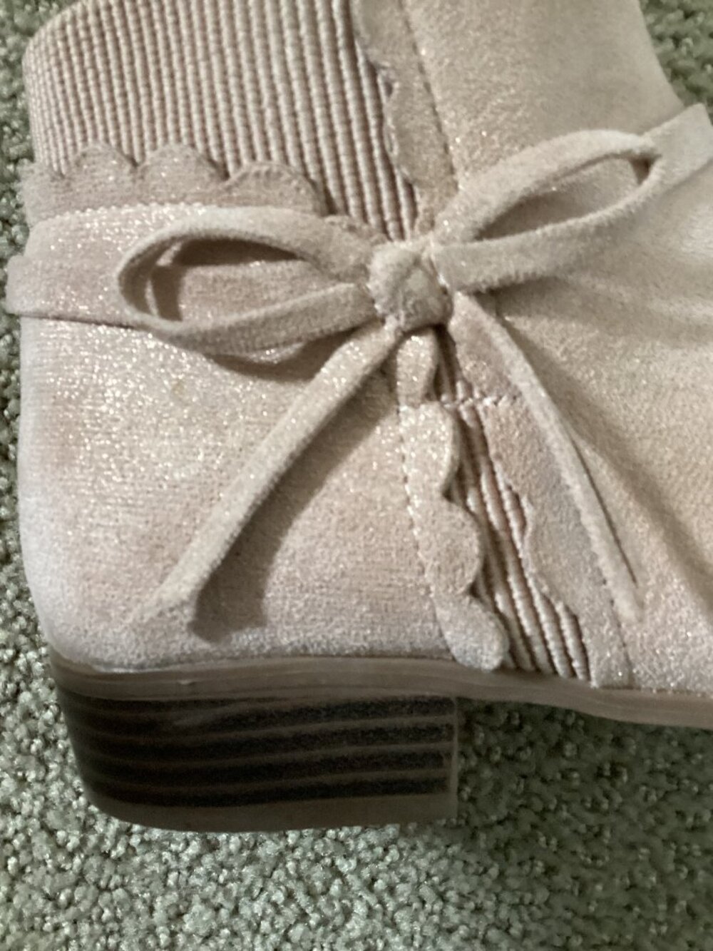 Heels for kids with bow on back of shoe.